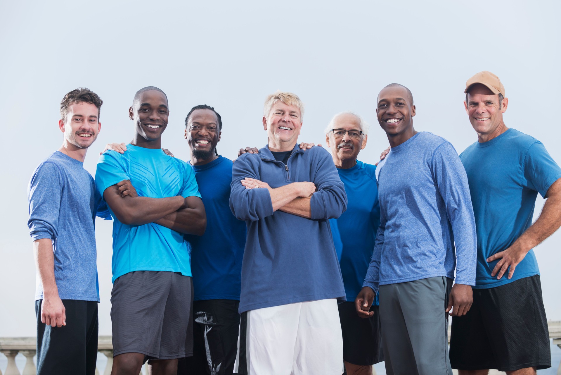 Multiracial group of men wearing blue shirts